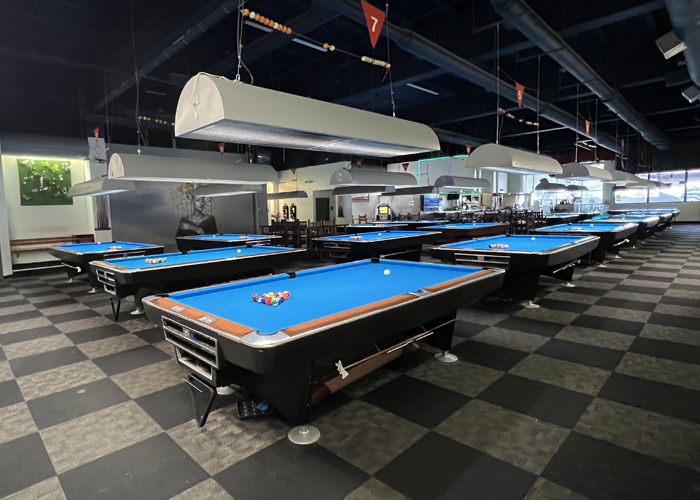 View of the pool hall from the back of the room.